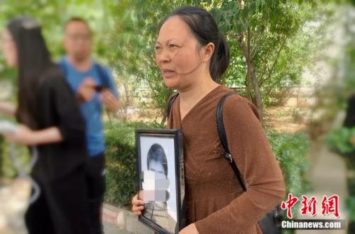 謝雕母親帶著謝雕的遺照走出法院 <a target='_blank' >中新網(wǎng)</a> 楊雨奇 攝 點(diǎn)擊進(jìn)入下一頁(yè)